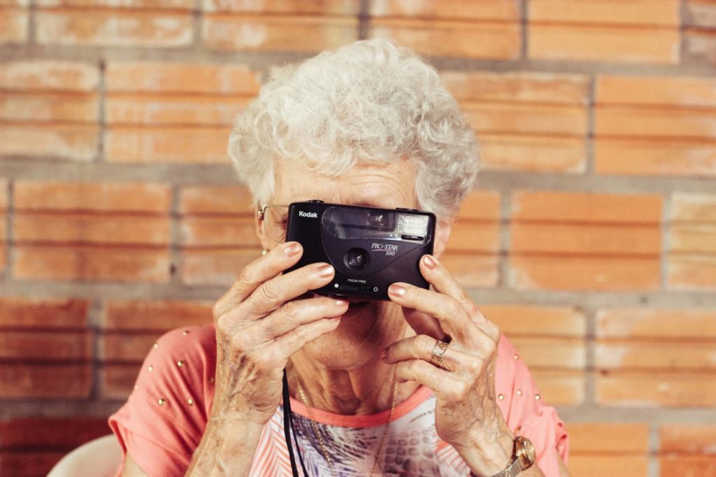 senior resident holding a camera