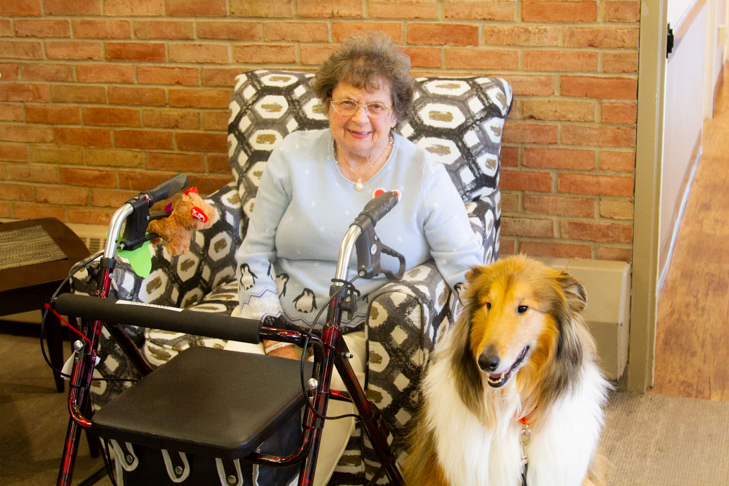 Brookcrest resident sitting with service dog Murphy