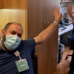 essential workers giving a safe high-five