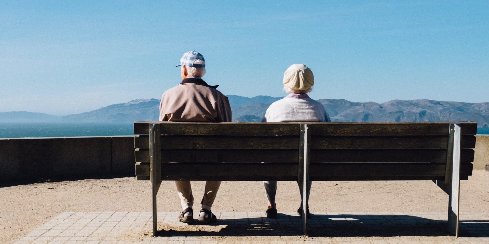 senior couple sitting on a bench