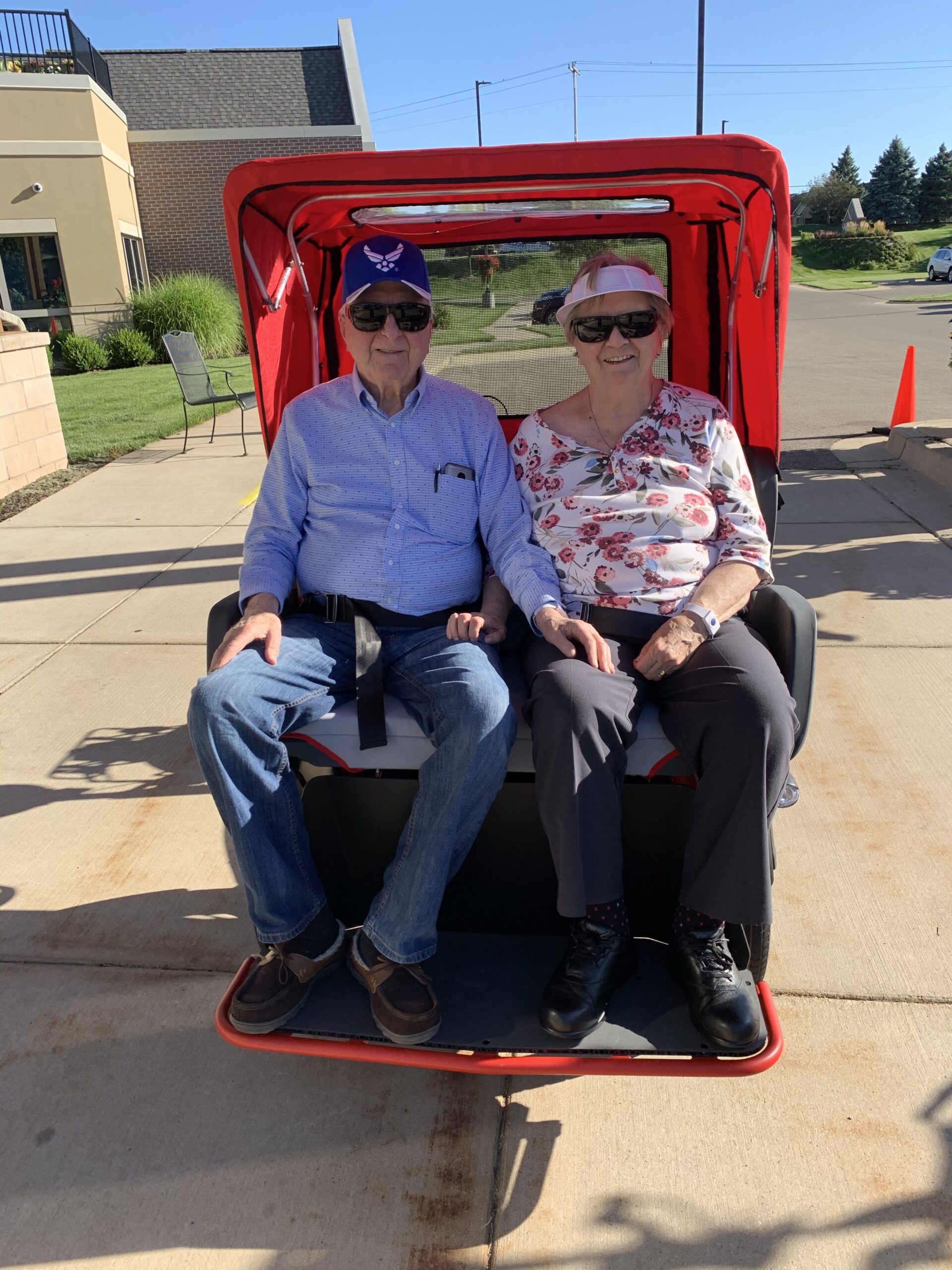 senior couple enjoying a ride in a three-wheeled trishaw