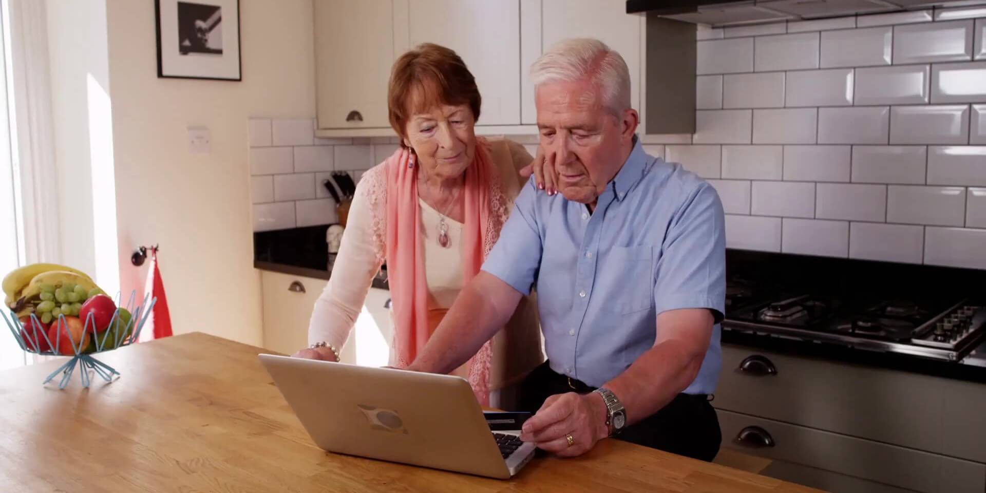 Senior couple looking at a laptop together